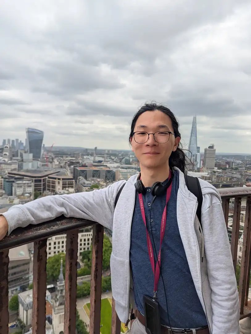 Portrait of myself standing in front of a London skyline.